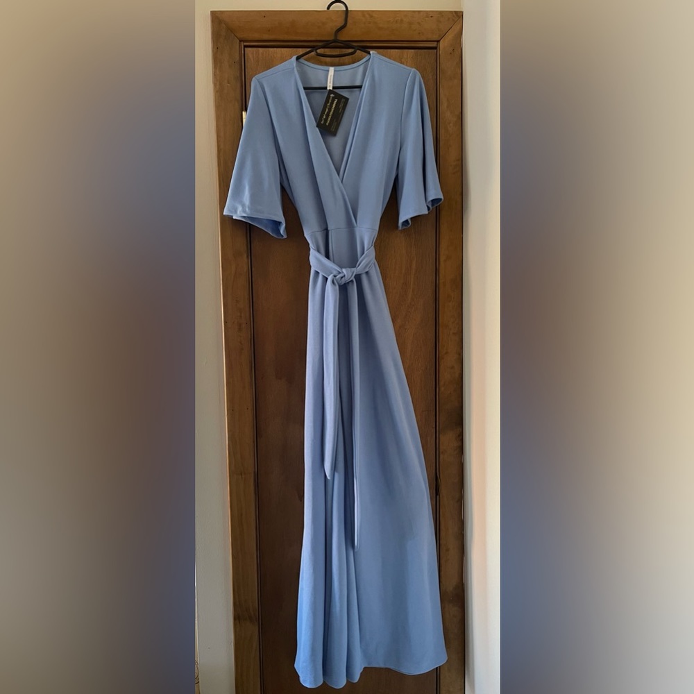 Powder blue jumpsuit with belt tie in front.  V neck collar, short sleeve